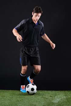 Take that chance before someone else does. Full length studio shot of a handsome young soccer player isolated on black.