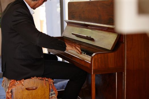 Artistic expression. a well-dressed man playing the piano.