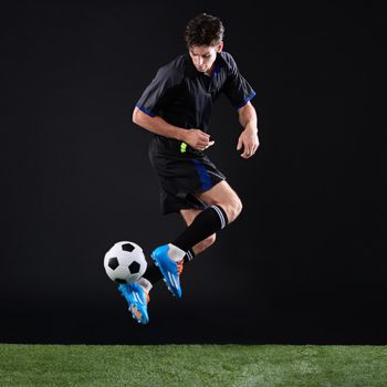 They cant stop what they cant catch. Full length studio shot of a handsome young soccer player isolated on black.