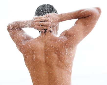 Revitalized and refreshed. a handsome young man enjoying a refreshing shower.