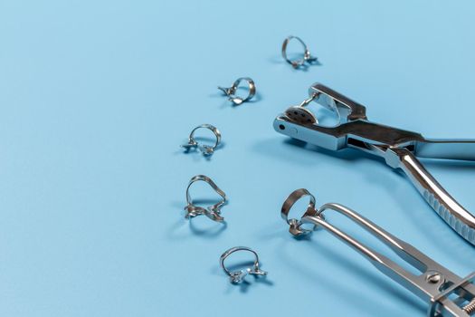 Dental hole punch, metal clamps and rubber dam forceps
