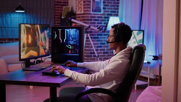 African american gamer playing online multiplayer game celebrating after winning online competition