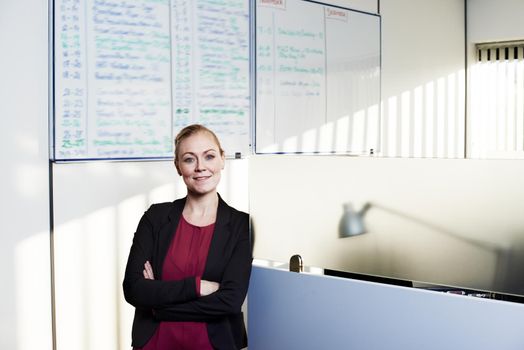 Corporate confidence. Portrait of an attractive businesswoman standing with her arms crossed in the office.