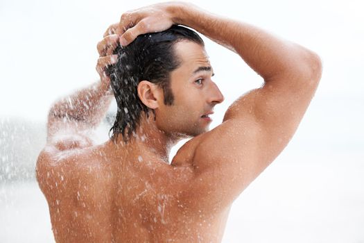 Fresh and fit. a handsome young man enjoying a refreshing shower.