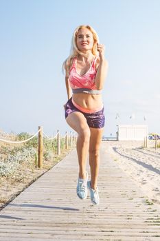 blonde sporty girl running for the promenade