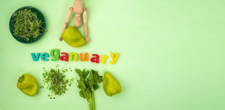 Veganuary written, vegan diet month in january called Veganuary. Flat lay. Copy space