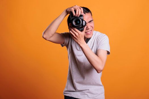 Photographer taking portrait photo on professional dslr camera