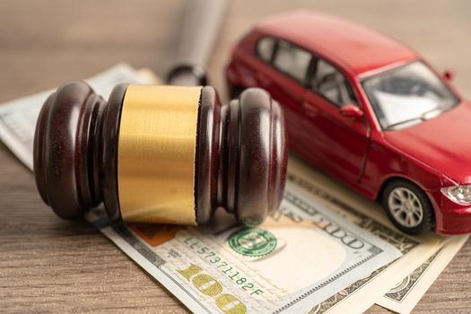 Gavel for judge lawyer with car on US dollar money banknotes, Car loan, Finance, saving money, law, insurance and leasing time concepts.