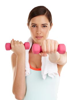 Dedicate yourself. a fit young woman working out with dumbbels.