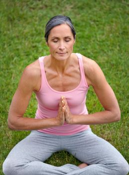 The art of meditation. an attractive mature woman practicing yoga in the lotus position.
