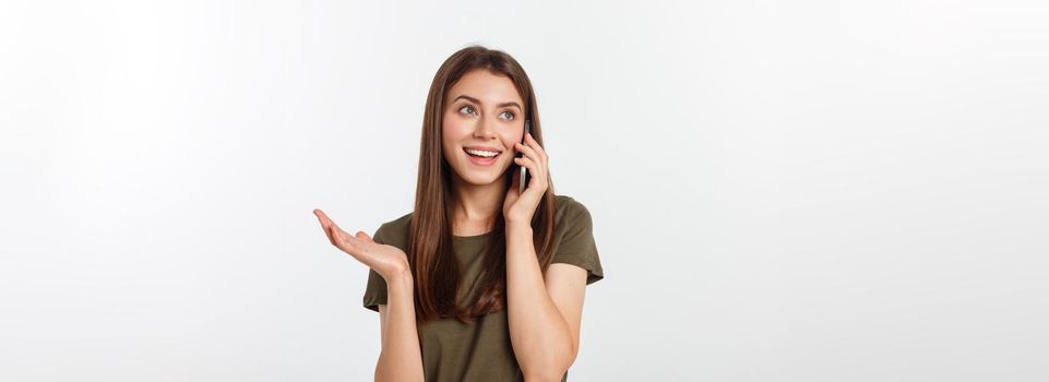 Laughing woman talking and texting on the phone isolated on a white background.