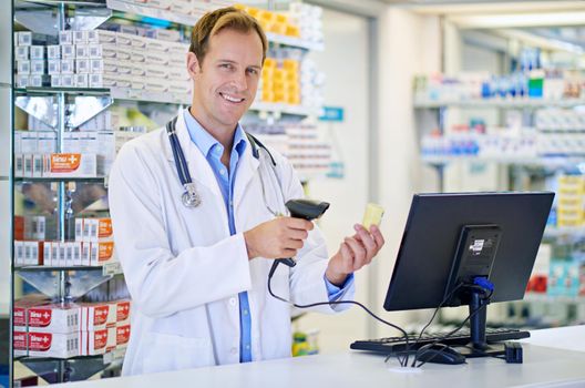 Keep calm and ask a pharmacist. A pharmacist scanning the price on a bottle of pills.