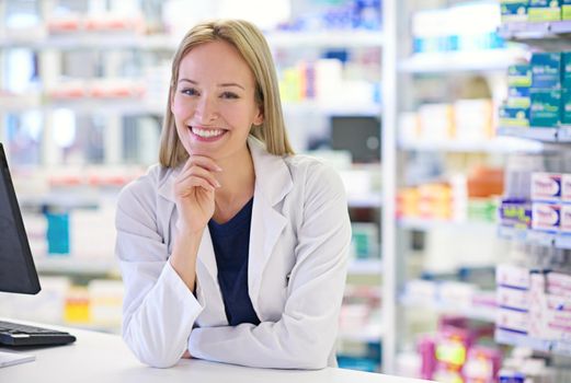 Helping my customers get better is the best feeling. Portrait of an attractive pharmacist standing at the prescription counter.