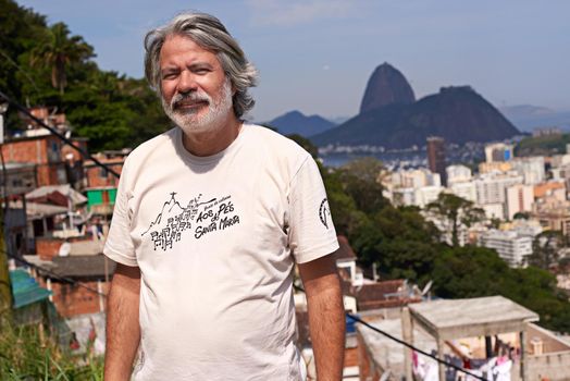 Proud of his country. Portrait of a mature brazilian man with the city as background.