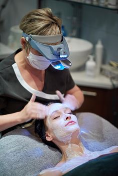 Rejuvenating youthfulness. a woman getting a facial treatment at a clinic.