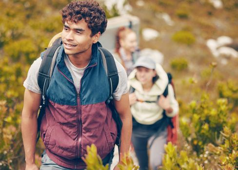Hiking, friends and adventure with a group of young people wearing backpacks during travel, adventure and nature journey. Active, fitness and exercise with a happy man trekking to explore with mates