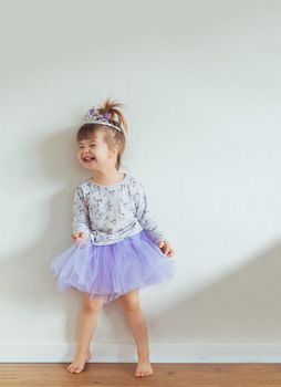 Charming child dancing at home. Space for text