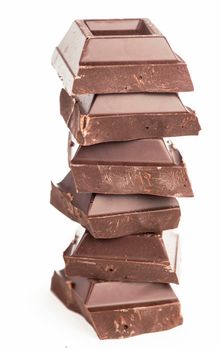 chocolate pieces. dark chocolate bars stacked high