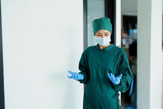 Portrait of a doctor wearing gloves before entering the operating room