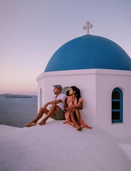 Couple of men and women on vacation in Santorini Greece, couple visit Oia Santorini