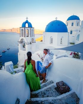 Couple of men and women on vacation in Santorini Greece, couple visit Oia Santorini