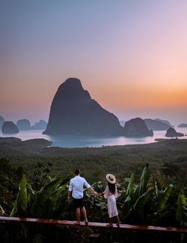 young men and women on vacation in Thailand Phannga watching the sunrise at Samet Nang She viewpoint
