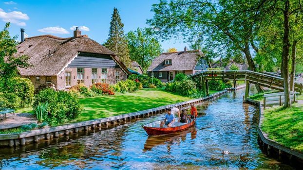 Giethoorn Netherlands, colorful village with canals and boats with tourist