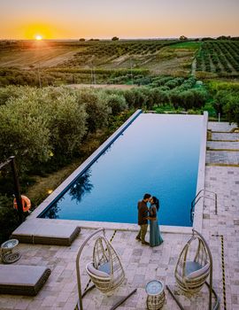 couple on vacation at luxury resort in Sicily during sunset by the infinity pool in Sicilia Italy