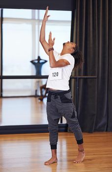 Dance as if no one is watching. Full length shot of a male dancer performing during a dance audition.