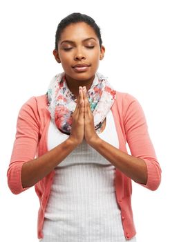 Meditation is the key to peace. A young woman meditating with her eyes closed.