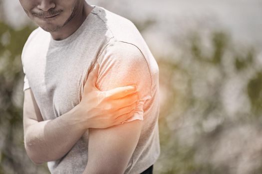Arm, muscle or pain injury of man during fitness, workout or outdoor exercise with nature bokeh. Overlay CGI of young sports athlete guy for medical insurance, healthcare emergency or inflammation