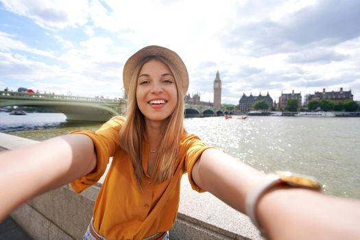 Holidays in UK. Brazilian girl takes selfie picture with smartphone in London, UK.