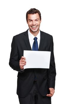 Holding some space for you. A handsome young businessman holding a placard while isolated on a white background.