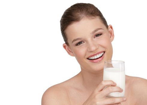 Enjoying a glass of fresh milk. A smiling teenage girl holding a glass of milk.