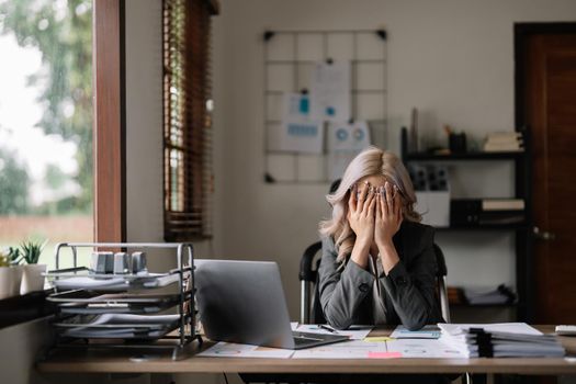 Businesswoman get stressed and feel headache while having a problem at work in office