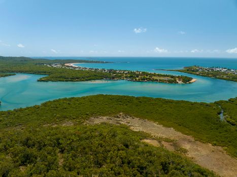 An Australian suburb by the sea with water and mangroves.