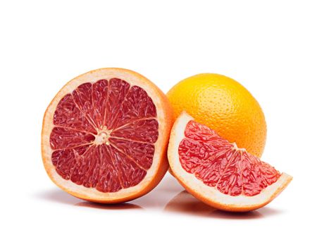 Juicy nutrients. Studio shot of a cut grapefruit with an orange in the background.