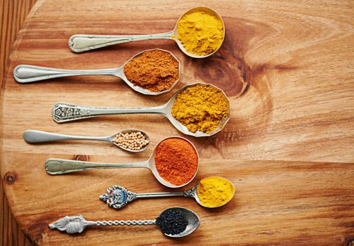 Flavors and spices. spoons filled with a variety of spices.