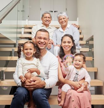 Big family, three generation and happiness of children, parents and grandparents sitting together on stairs in their home while smiling. Bond, support and closeness of kids with man and woman