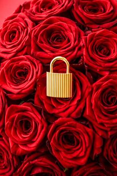 Love lock for Valentines Day card, golden padlock and luxury bouquet of roses on red background