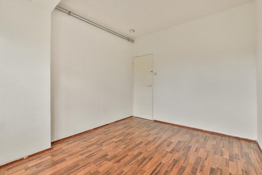 Empty room with white walls and parquet floor