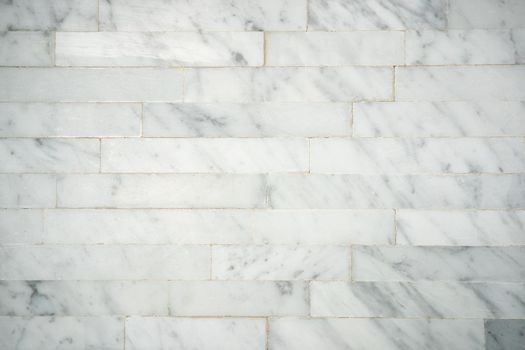 Pattern square shape of tile surface on white marble decorative wall.
