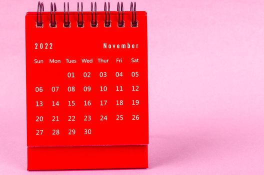 The Red November 2022 Monthly desk calendar for 2022 year on pink background.