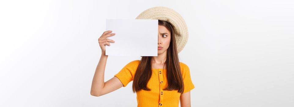 Young caucasian woman holding blank paper sheet over isolated background scared in shock with a surprise face, afraid and excited.