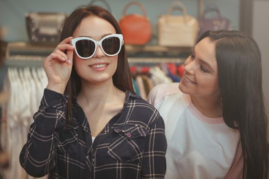 Charming young women shopping for eyewear