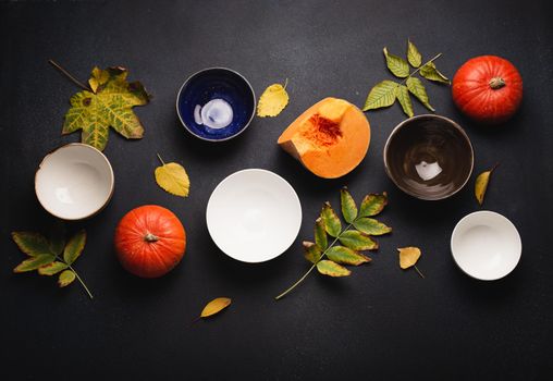 Fall composition with pumpkins and empty plates