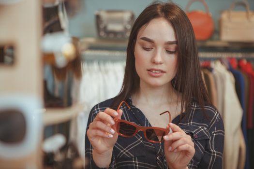 Charming young woman shopping for eyewear