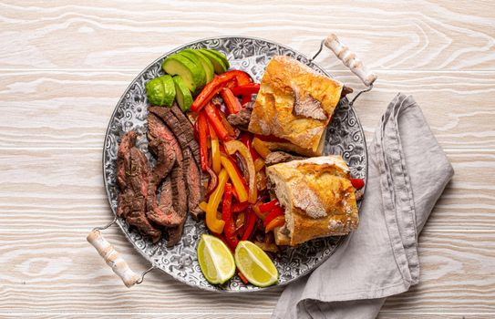 Mexican fajita sandwiches on wooden table from above