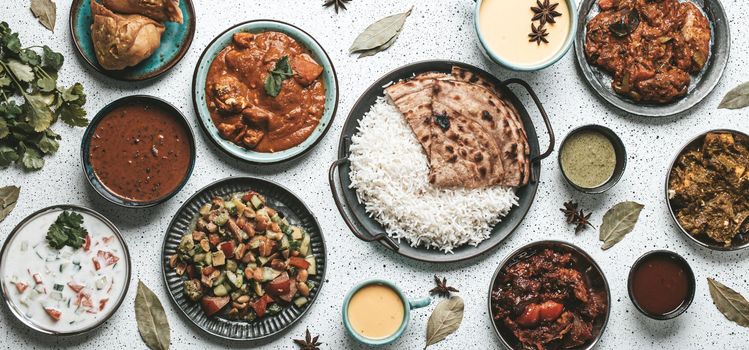 Indian ethnic food buffet on white concrete table from above