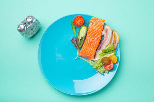 Intermittent fasting low carb hight fats diet concept flat lay, healthy food on blue plate